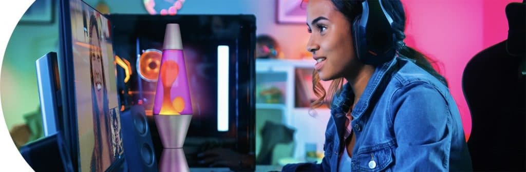 category-electronicsandlighting Lava Lamp Category - Girl with headphones chatting on the computer - Silver Lava Lamp with Orange wax and purple on her desk