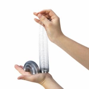 Mini Sproing stretched between two hands with one Mini Sproing in Palm