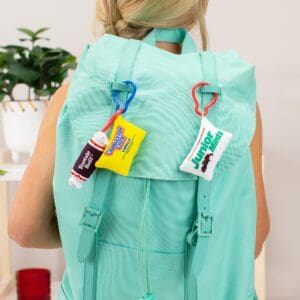 Lifestyle shot of Tootsie Roll Charleston Chew Junior Mints Snacks on Snacks plush danglers on backpack