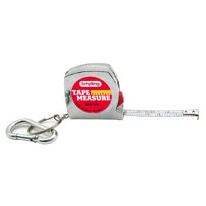 TPM_Image1 A small tape measure labeled "Schylling Tape Measure" is shown with a metal carabiner attached. The tape is partially extended, displaying measurements in both inches and centimeters. The casing is metallic with a red and yellow label.