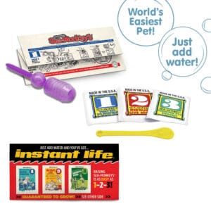 Three packets, numbered 1, 2, and 3 from left to right. There is a small yellow Sea-Monkeys spoon laying in front of the packets. There is a purple pipette and folded instruction paper laying behind the packets, and a peice of the box highlighted in front of the packets. There are two callouts in circles. One reads "World's Easiest Pet!" and the other reads "Just add water!" Three packets, numbered 1, 2, and 3 from left to right. There is a small yellow Sea-Monkeys spoon laying in front of the packets. There is a purple pipette and folded instruction paper laying behind the packets, and a peice of the box highlighted in front of the packets. There are two callouts in circles. One reads "World's Easiest Pet!" and the other reads "Just add water!"